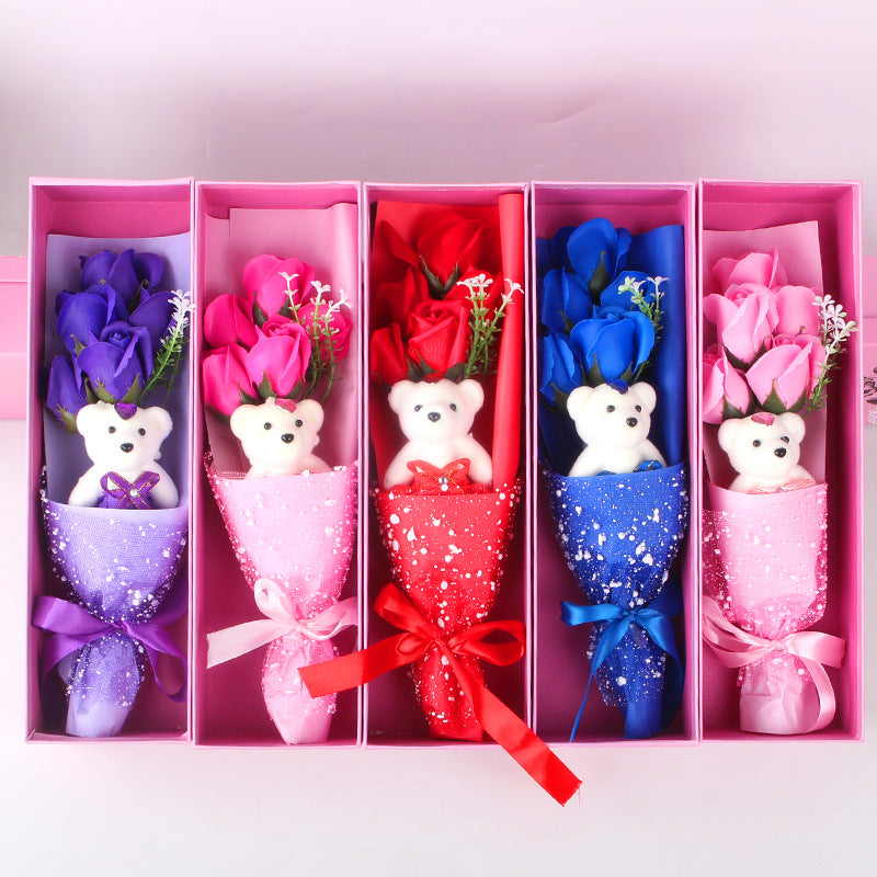 Aromatic soap roses and a soft teddy bear, carefully arranged in a decorative box, ideal for gifting loved ones.