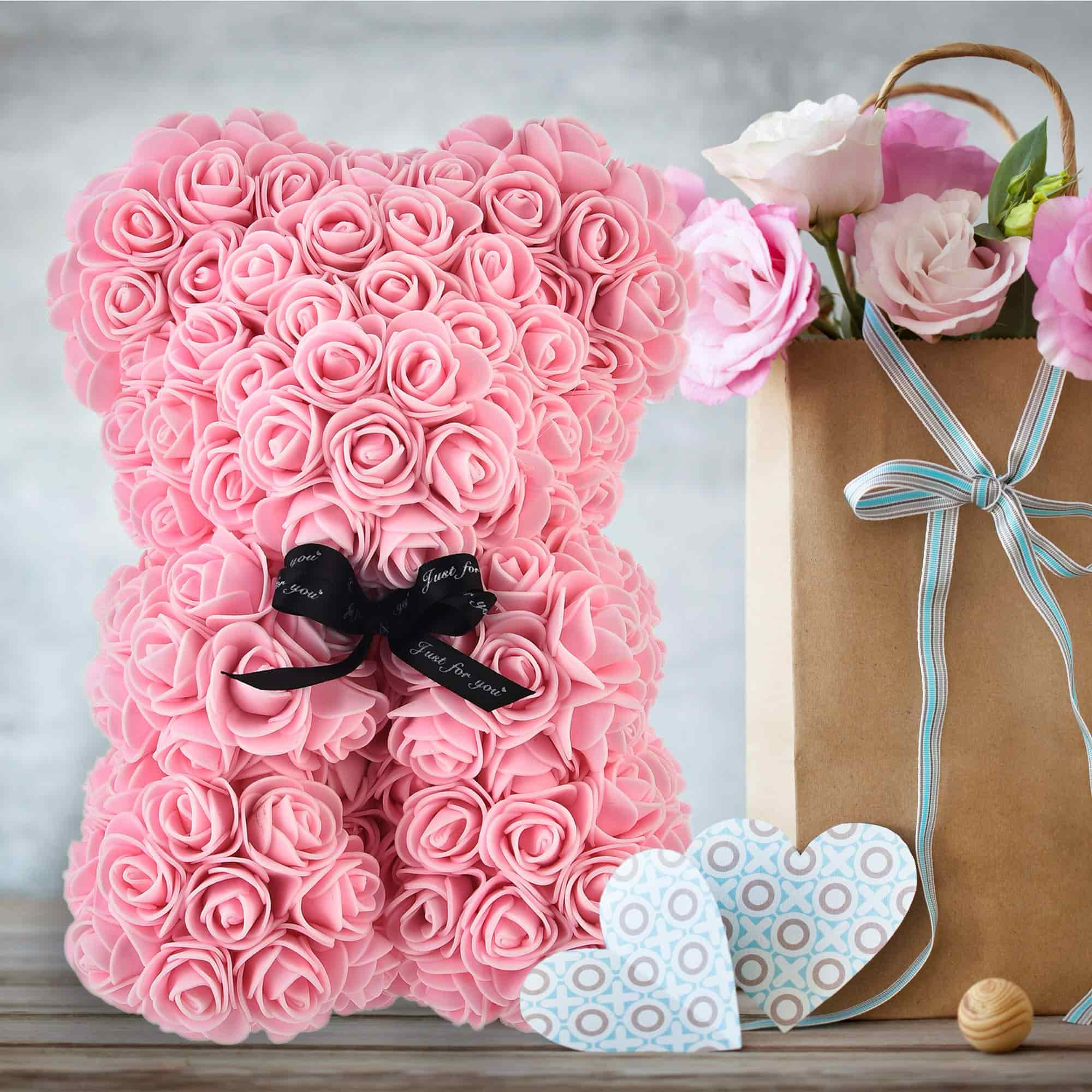 Lovingly crafted rose teddy bear with a ribboned gift box, a thoughtful and romantic gesture for any special day.