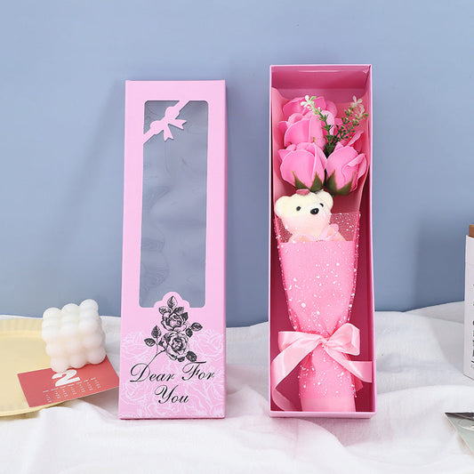 Elegantly crafted soap roses accompanied by a soft teddy bear in a decorative box, making it a thoughtful gift for loved ones.