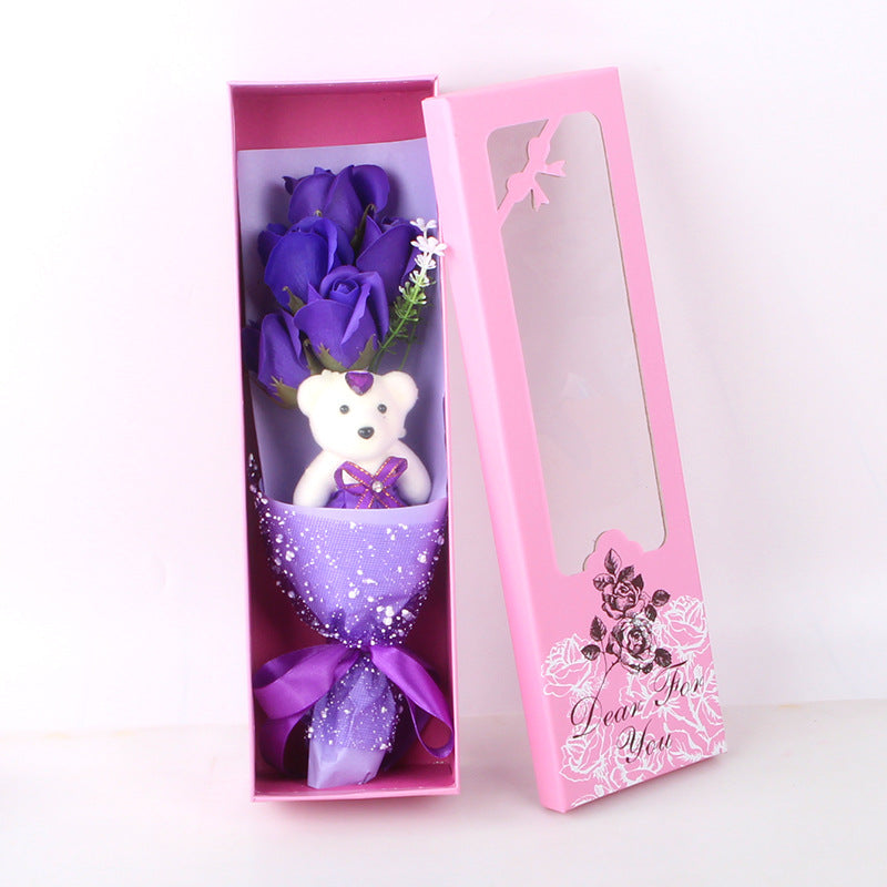 Five fragrant soap roses and a soft teddy bear, elegantly packaged, ideal for gifting on anniversaries or special days.