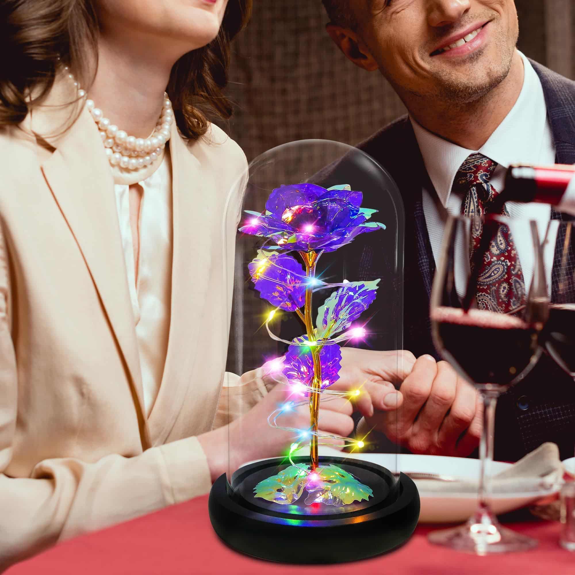 Enchanted purple rose under a glass dome with LED lights, ideal for special occasions.