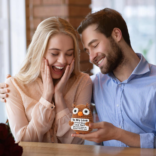 Romantic crochet owl plush gift held by couple