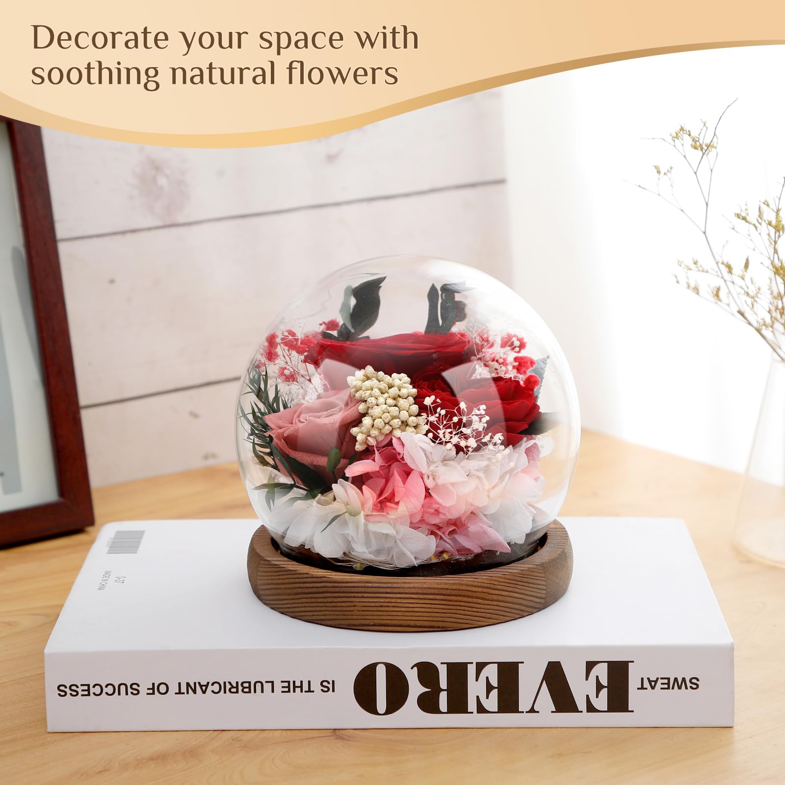 Preserved flowers in elegant glass dome.
