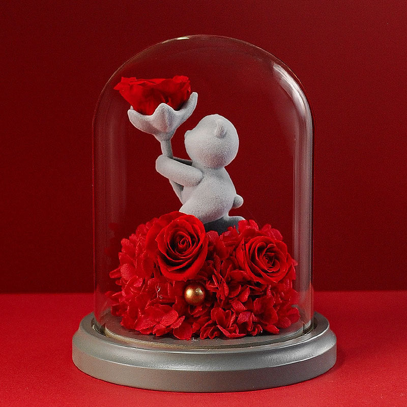 Cupid-themed teddy bear in a glass dome with an eternal rose, an ideal romantic gift for anniversaries, weddings, or Valentine's Day.