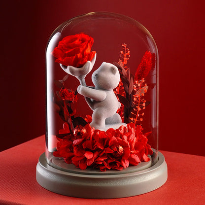 Flower presenting teddy bear with an eternal rose in a glass dome, a thoughtful gift for loved ones on special occasions.