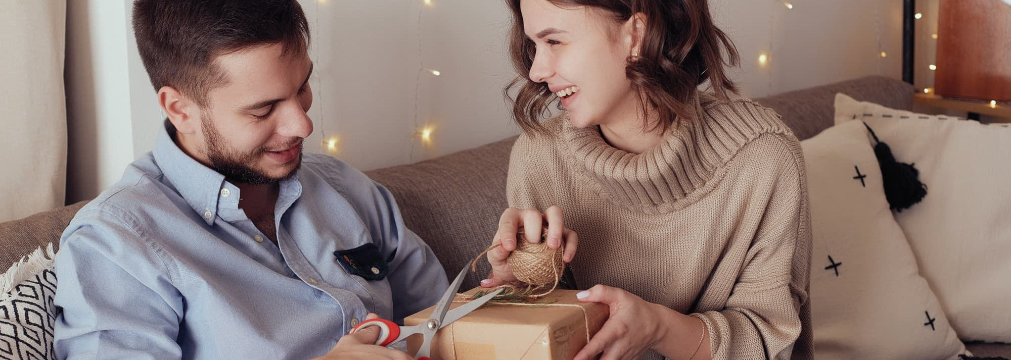 young-cheerful-couple-love-with-gift-christmas
